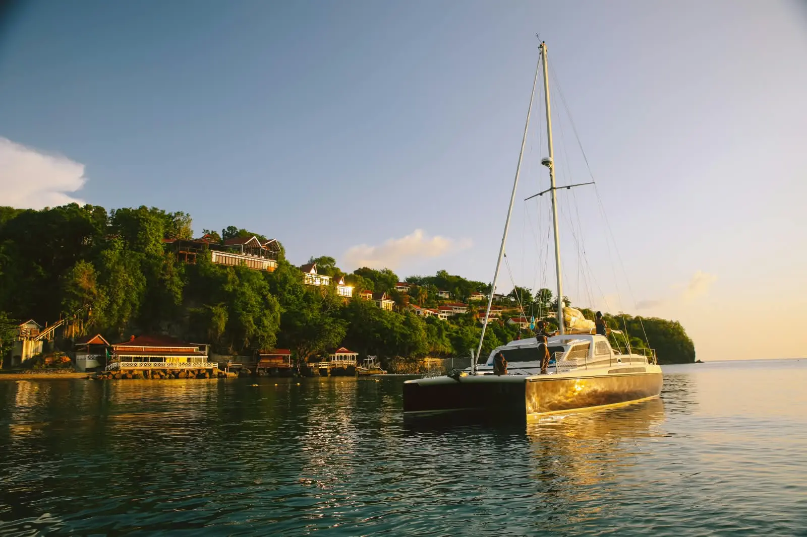 Bliss at anchor in the warm evening light below a wooded hillside