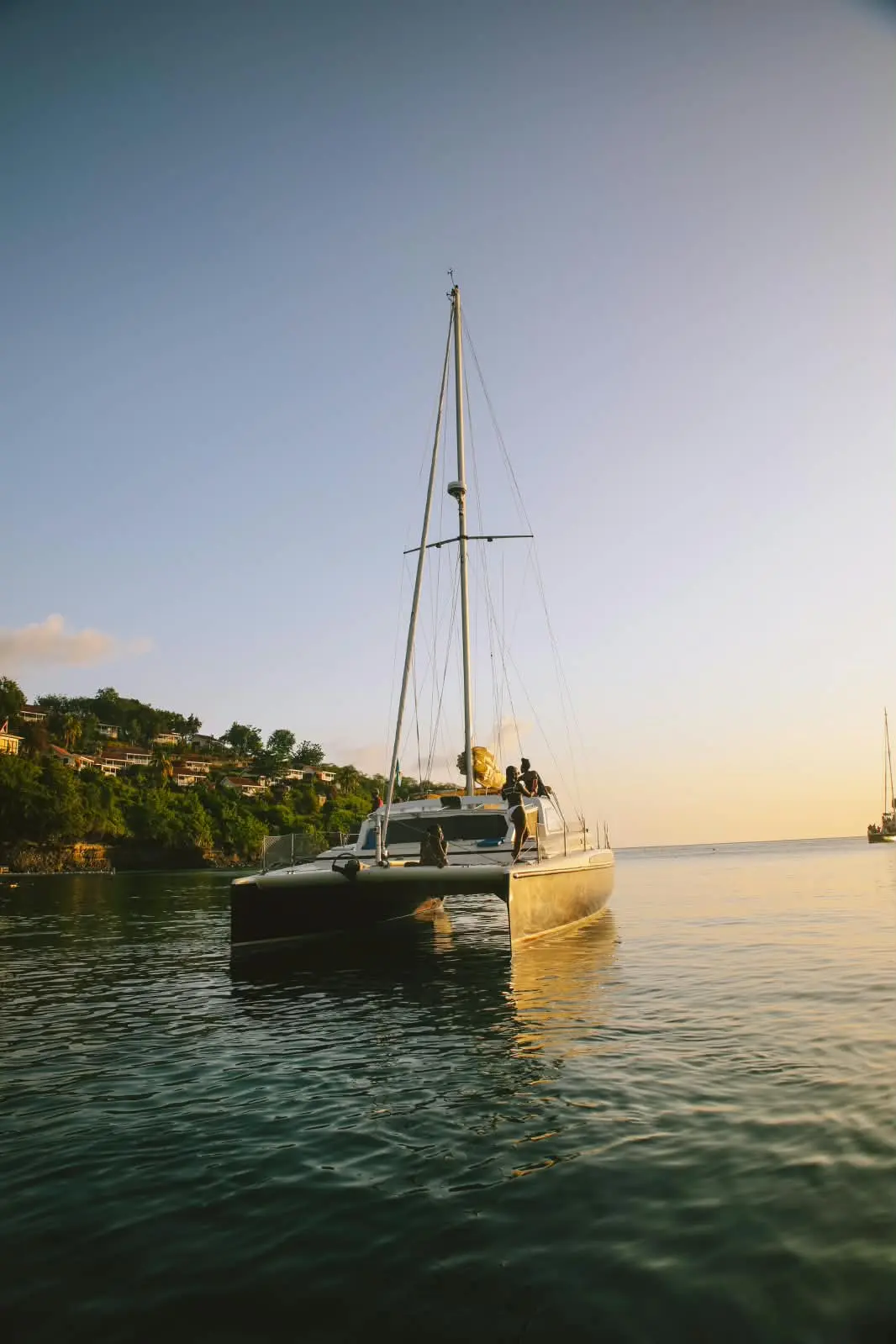 Bliss at anchor in calm water as the sun goes down